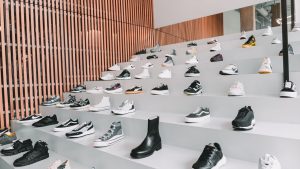 A diverse collection of sneakers displayed in a modern retail store with stylish interior design.